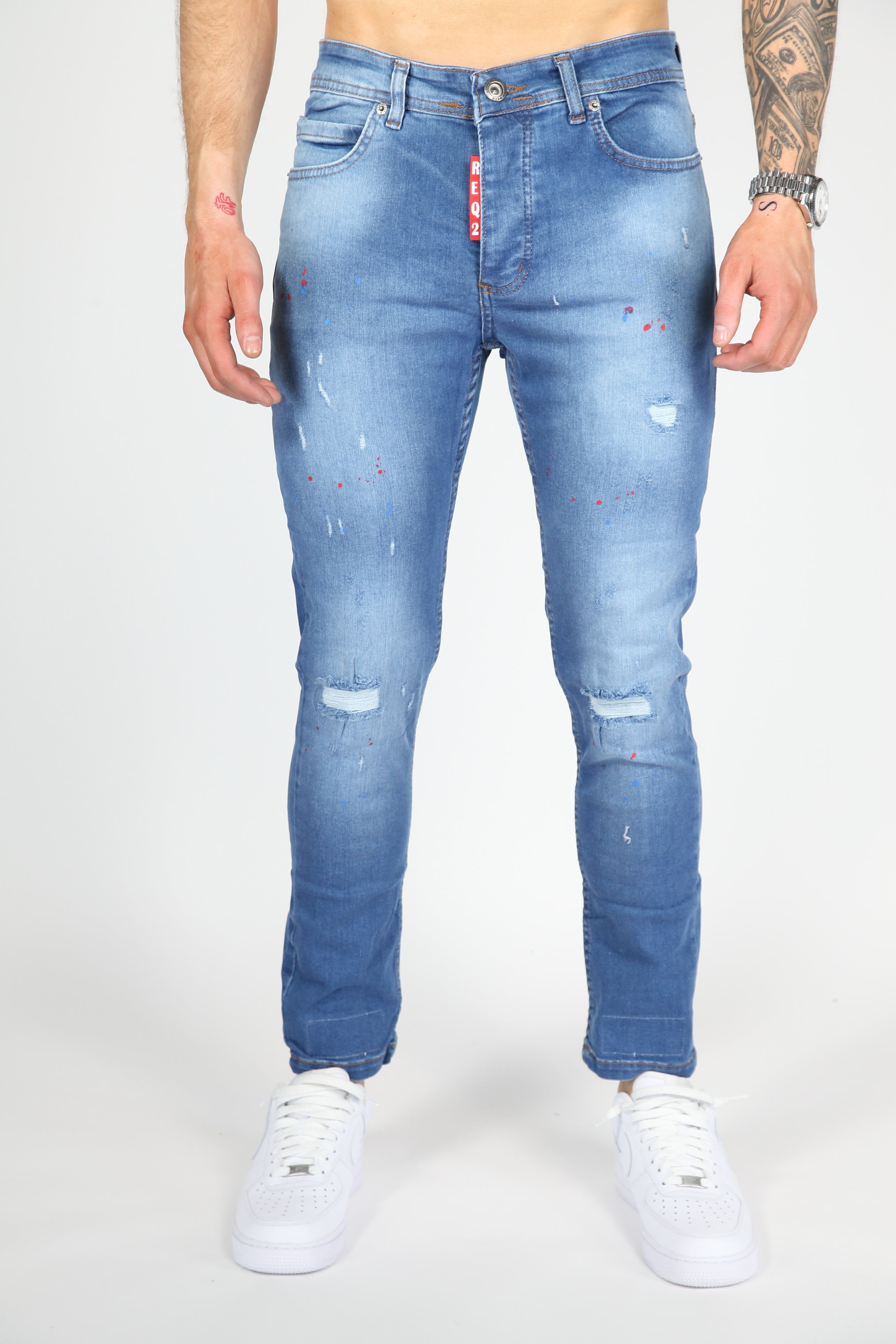 Il danno da strada danno jeans magri blu