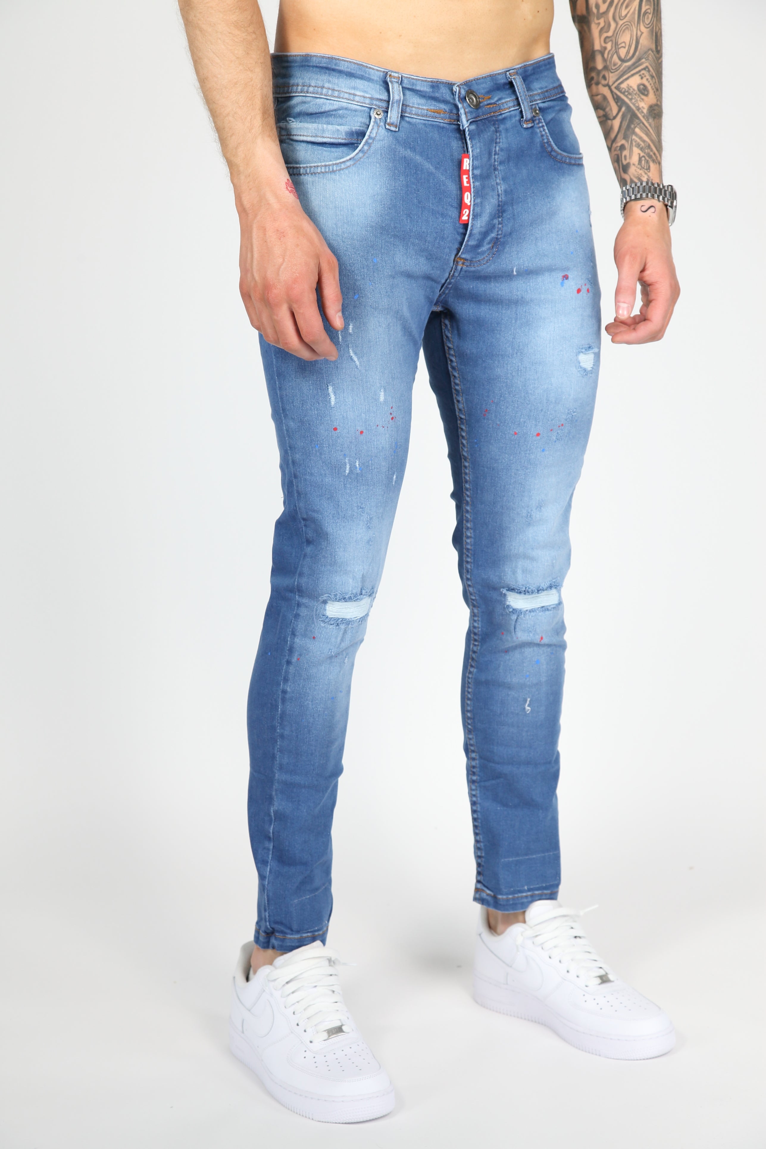 Il danno da strada danno jeans magri blu