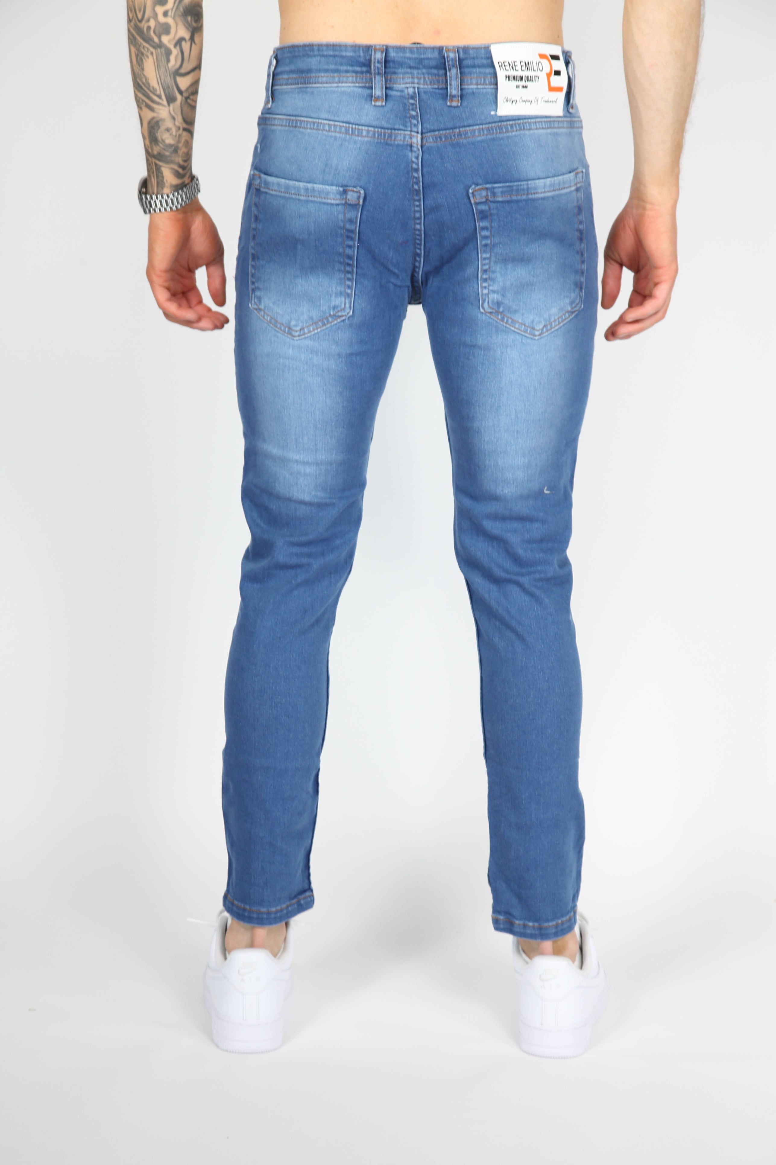 Il danno da strada danno jeans magri blu